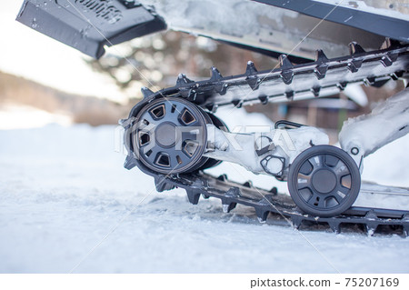 Rear suspension of a snowmobile in winter. Riding in the snow 75207169