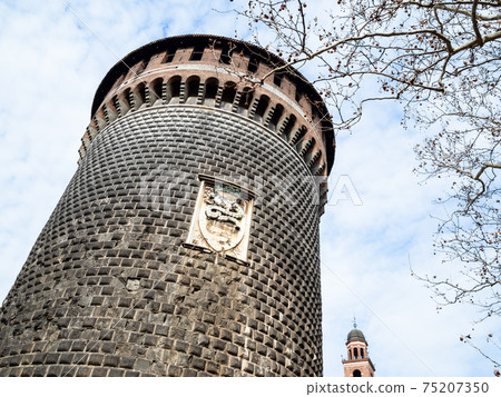 Tower and bare tree branches in Milan in spring 75207350