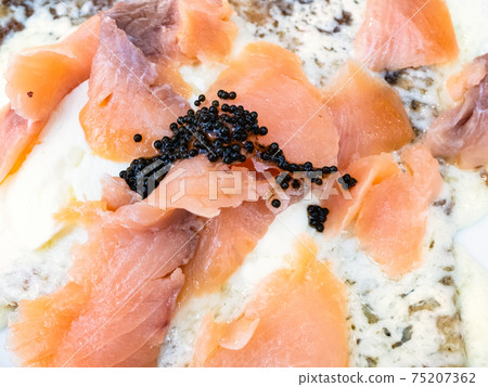 salmon slices with black caviar on crepes close up salmon slices with black caviar on crepes close up 75207362