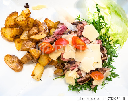 top view sliced beef with rustic roasted potatoes top view sliced beef with rustic roasted potatoes 75207446