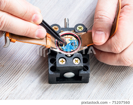 view of watchmaker replacing battery in watch view of watchmaker replacing battery in watch 75207560