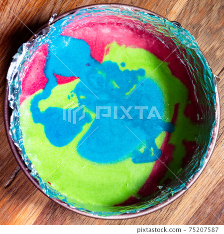 multicoloured mix of raw dough in springform pan multicoloured mix of raw dough in springform pan 75207587
