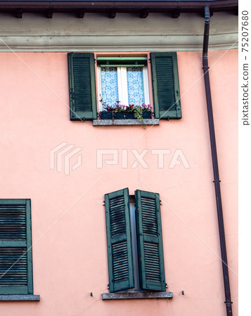 pink wall of medieval house in Lecco town 75207680