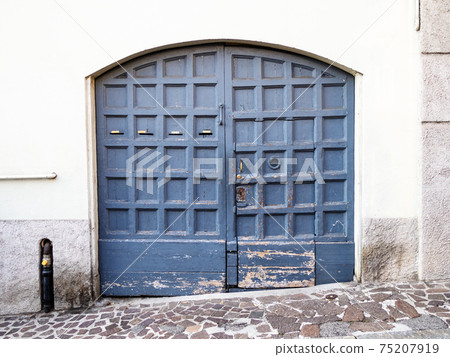 wide medieval gray wooden door in Bergamo 75207919