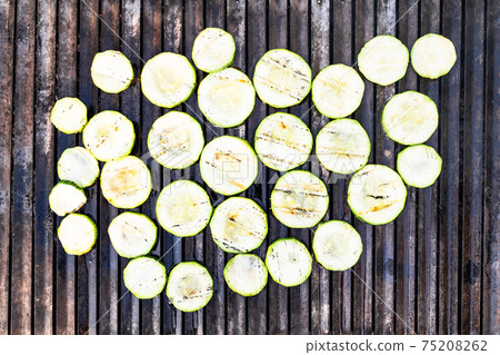 roasted slices of zucchini on outdoor grill roasted slices of zucchini on outdoor grill 75208262