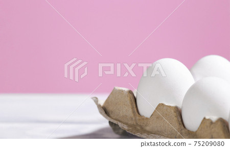 White Chicken eggs in a cardboard box on a pink background, Raw Fresh Eggs in a paper container, Natural Eko Product, Copyspace, Trendy Background 75209080