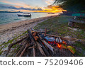 Fish bbq on tropical desert beach. Cooking barbecue with wood fire at sunset, colorful sky on sea, dramatic clouds, getting away, adventure in Indonesia Sumatra Banyak Islands 75209406