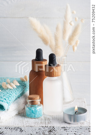 Cosmetic essential oil on wooden background 75209432