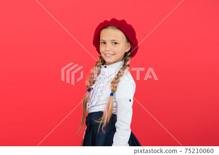 learning french. happy child in uniform. little girl in french 75210060