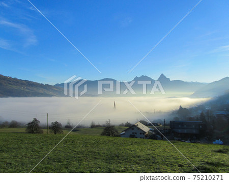 View from the slopes of mount Rigi, Switzerland towards Aarth-Goldau in the fog 75210271