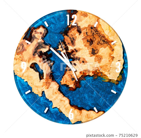 Beautiful round wooden wall clock made of tree root and blue epoxy resin isolated on white background. Beautiful round wooden wall clock made of tree root and blue epoxy resin isolated on white background. 75210629