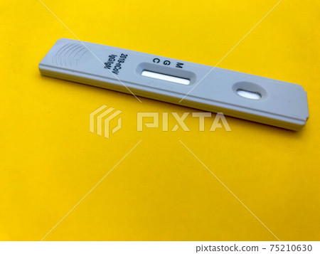 medical procedures. coronavirus test on a bright yellow background. home kit for self-diagnosis. medical procedures for the determination of IgG and IgM antibodies 75210630