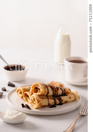 Russian thin pancakes with chocolate. Russian thin pancakes with chocolate. 75211009