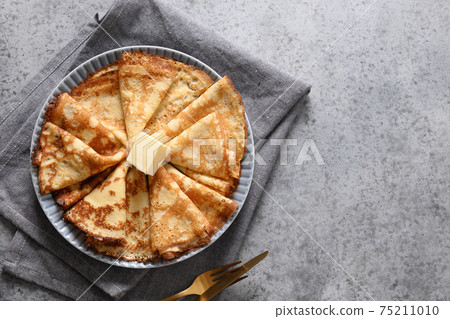 Russian thin pancakes or blini with red caviar on grey. Russian thin pancakes or blini with red caviar on grey. 75211010