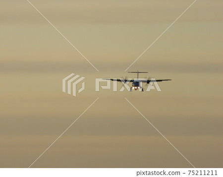 Propeller plane at dusk 75211211
