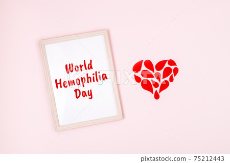 World Hemophilia Day background. Hemophilia awareness poster. Red drops heart and text World Hemophilia Day on pink background 75212443