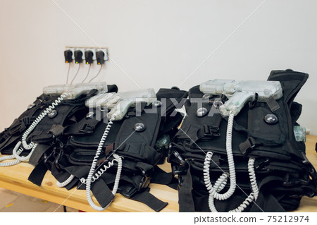 Weapons close-up on a military man standing inside the building and waiting for command. 75212974