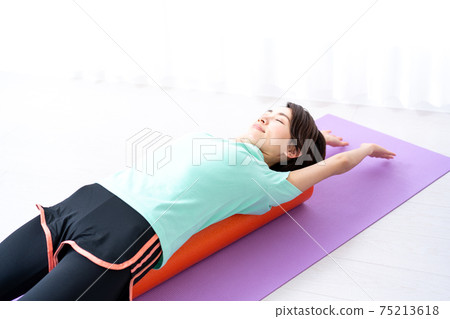 Middle woman relaxing on a stretch pole Middle woman relaxing on a stretch pole 75213618