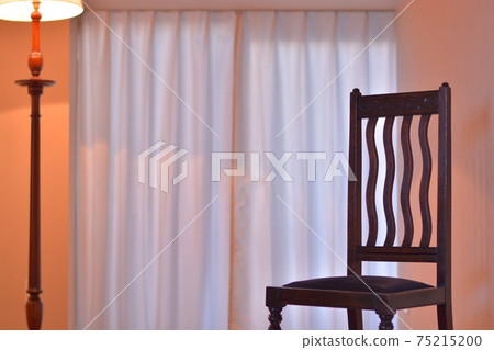 Oak chair on the windowsill. With lamp stand. British antique furniture (dim light, soft focus) Oak chair on the windowsill. With lamp stand. British antique furniture (dim light, soft focus) 75215200