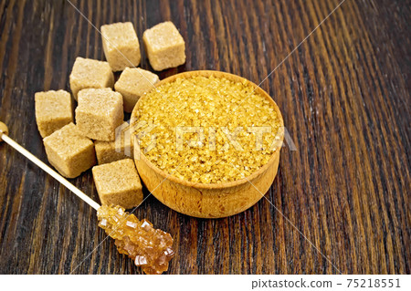 Sugar brown in bowl on wooden board Sugar brown in bowl on wooden board 75218551