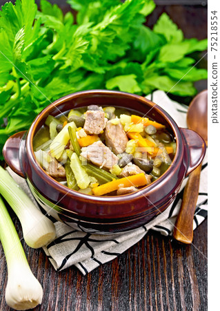 Soup Eintopf in clay bowl on table 75218554