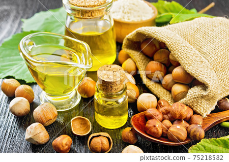 Oil hazelnut in vial on black board Oil hazelnut in vial on black board 75218582