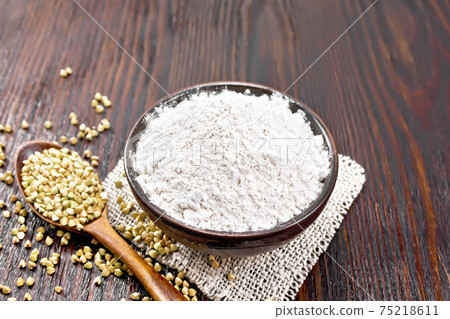 Flour buckwheat green in bowl on board 75218611