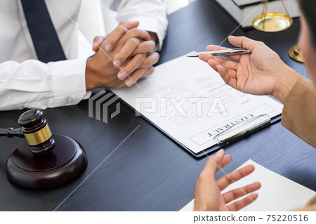 Lawyer or judge present client with contract document papers, Law and Legal services concept Lawyer or judge present client with contract document papers, Law and Legal services concept 75220516