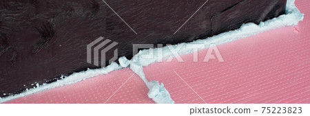 Construction foam between pink extruded styrofoam sheets Construction foam between pink extruded styrofoam sheets 75223823