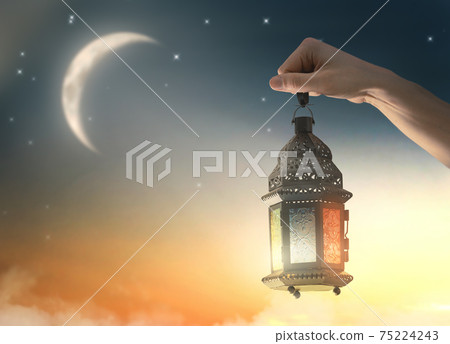 Ornamental Arabic lantern with burning candle 75224243