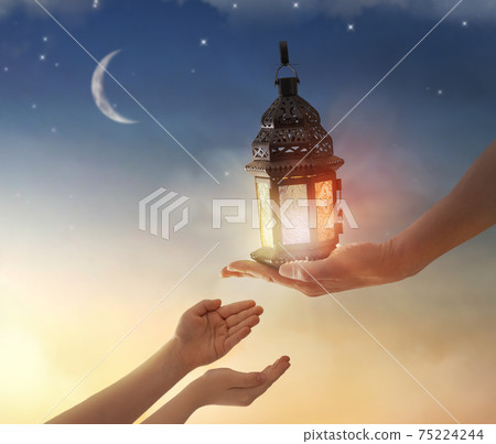 Ornamental Arabic lantern with burning candle 75224244
