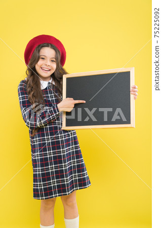 Back to school. Small school child pointing finger at blank Back to school. Small school child pointing finger at blank 75225092