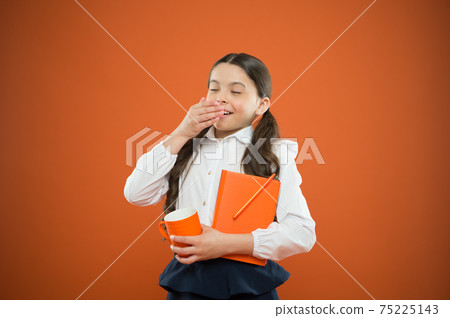 Calories fuel for brain. Schoolgirl with mug having tea 75225143