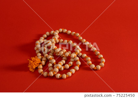 Religious beans on red background with copy space. Shot with light shadow. Religious beans on red background with copy space. Shot with light shadow. 75225450