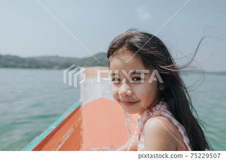 little girls sitting in boat 75229507