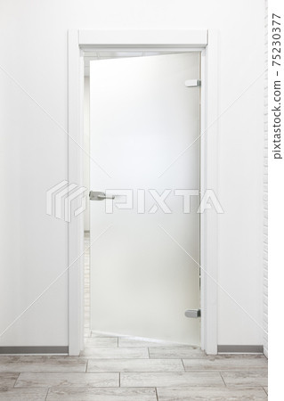Minimalist white office interior with frosted glass door ajar Minimalist white office interior with frosted glass door ajar 75230377