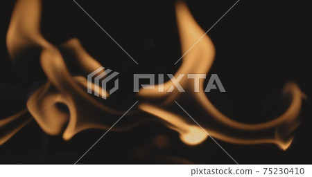 Fire dancing against dark background Fire dancing against dark background 75230410