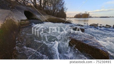 Large sewage tunnel with filth flowing out Large sewage tunnel with filth flowing out 75230491