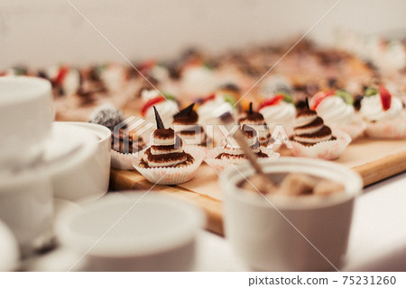 muffins and white cups. Production of muffins and pastries muffins and white cups. Production of muffins and pastries 75231260
