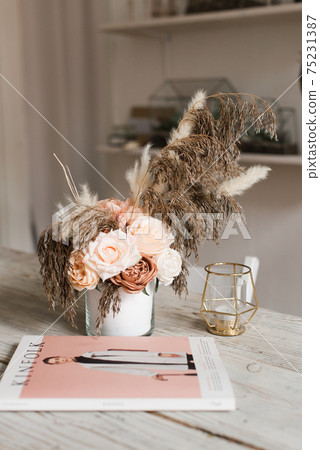 artificial decorative flowers on a wooden table. wood texture artificial decorative flowers on a wooden table. wood texture 75231387