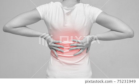 The person is massaging the back because of the feeling of pain from sciatica and neurology. The person is massaging the back because of the feeling of pain from sciatica and neurology. 75231949