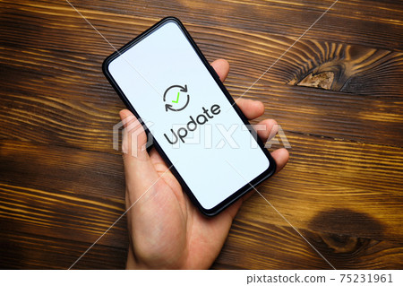 Person hand holds smartphone after system update 75231961