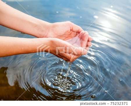 Holding water in cupped hands Holding water in cupped hands 75232371