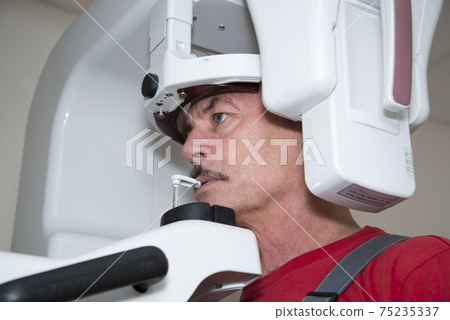 The technician repairs Digital Panoramic X-ray Sistem The technician repairs Digital Panoramic X-ray Sistem 75235337