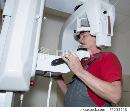 The technician repairs Digital Panoramic X-ray Sistem The technician repairs Digital Panoramic X-ray Sistem 75235338