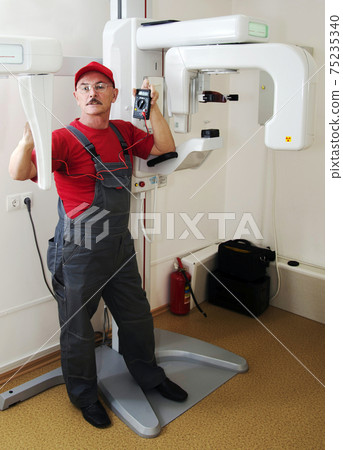 The technician repairs Digital Panoramic X-ray Sistem The technician repairs Digital Panoramic X-ray Sistem 75235340