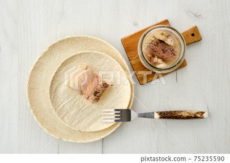 Top view of canned sturgeon on a plate. 75235590