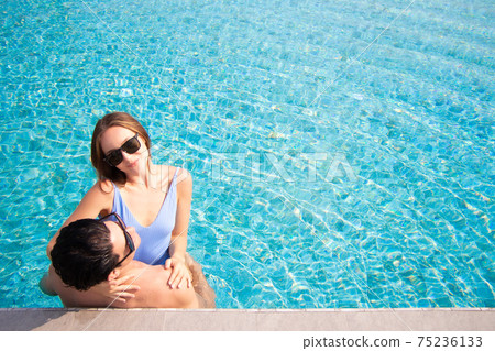 Sexy happy caucasion white couple embracing in swimming pool vacation Sexy happy caucasion white couple embracing in swimming pool vacation 75236133