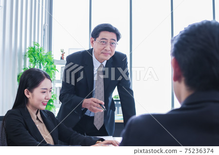 asian group meeting business people. Senior tranning Asian Businessman. Group discussion. Happy faces of suitma. Working for success in office. asian group meeting business people. Senior tranning Asian Businessman. Group discussion. Happy faces of suitma. Working for success in office. 75236374