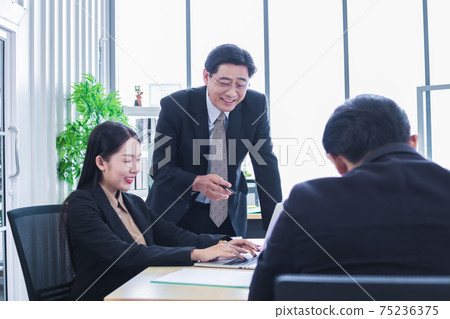 asian group meeting business people. Senior tranning Asian Businessman. Group discussion. Happy faces of suitma. Working for success in office. asian group meeting business people. Senior tranning Asian Businessman. Group discussion. Happy faces of suitma. Working for success in office. 75236375